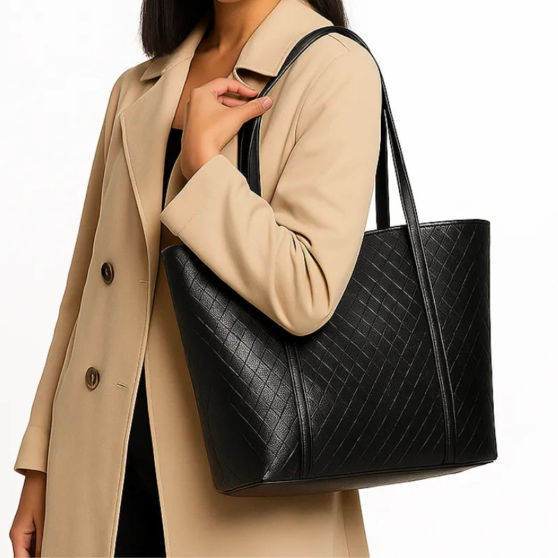 Modelo usando a bolsa tote preta tramada. A imagem mostra o acessório sendo carregado no ombro, realçando seu visual moderno e elegante.