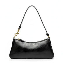 Vista superior da bolsa de ombro baguete preta aberta. A foto revela o interior com forro claro, bolsos internos e o fechamento por zíper.