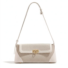 Bolsa de ombro feminina bege em canvas e couro PU, vista frontal. A foto destaca o design elegante e a trava dourada giratória.