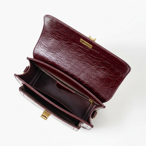 Bolsa crossbody feminina couro vinho Rozze aberta mostrando interior espaçoso.