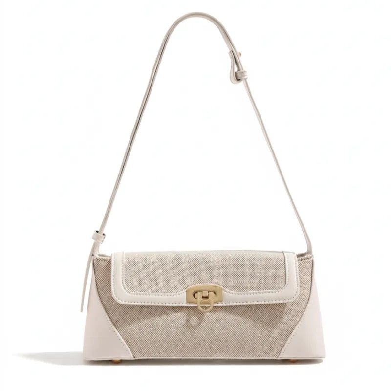 Bolsa de ombro bege canvas trava dourada em vista frontal, com formato, alça e ferragens visíveis, sobre fundo claro
