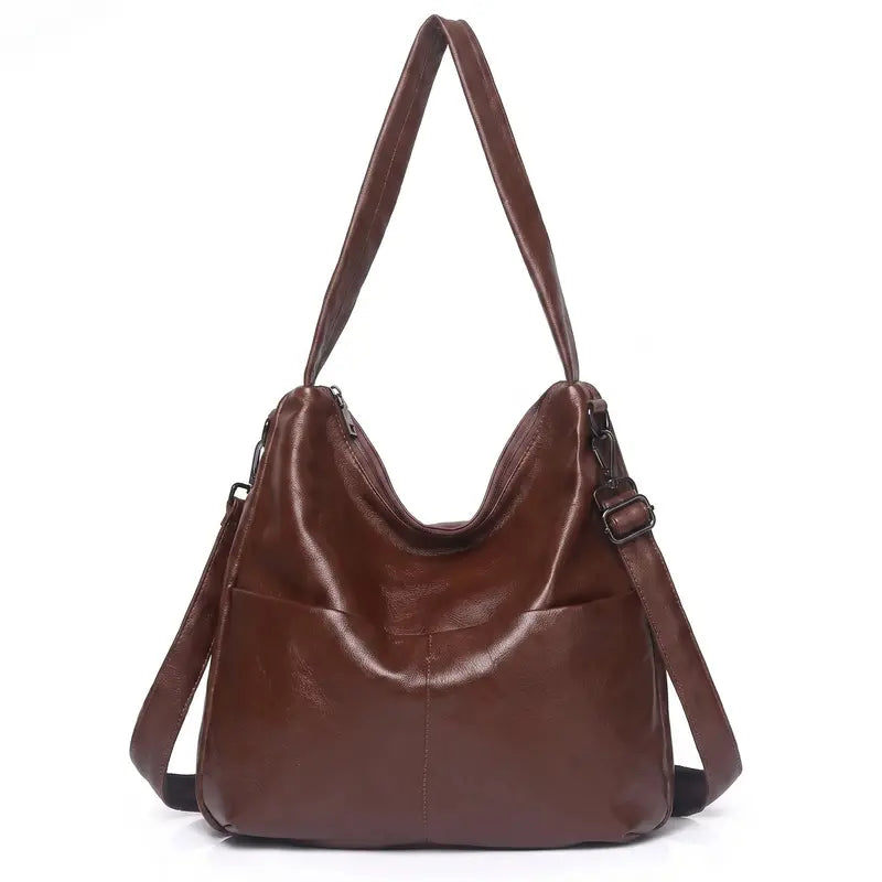 Bolsa hobo clássica castanho em couro legítimo em vista frontal, destacando formato curvo, alça e acabamento.