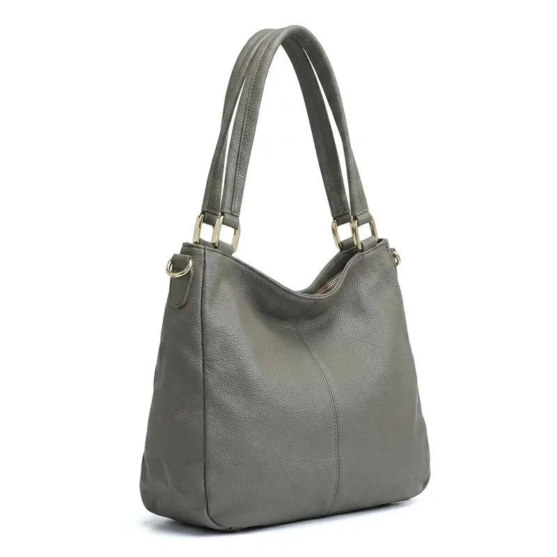 Bolsa hobo couro genuíno cinza retrô em vista lateral, com profundidade, alça e acabamento visíveis, sobre fundo claro