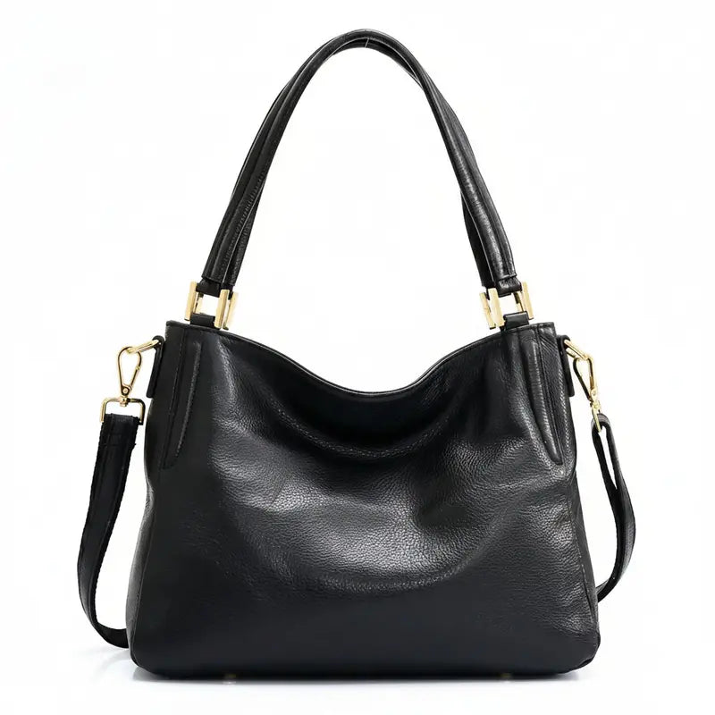 Bolsa hobo couro genuíno preta retrô em vista frontal, com formato, alça e ferragens visíveis, sobre fundo claro