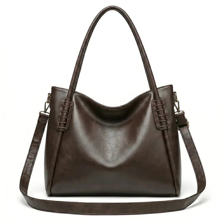 Bolsa hobo vintage marrom café em vista frontal, com formato, alça e ferragens visíveis, com acabamento uniforme