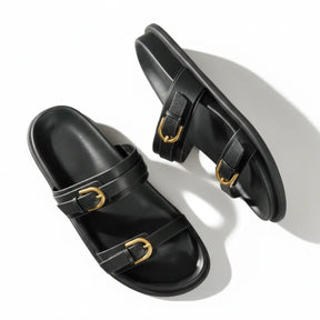 Papete preta com dupla fivela dourada vista de cima mostrando o par.