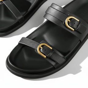 Papete preta com dupla fivela dourada em angulo lateral mostrando os dois pares.