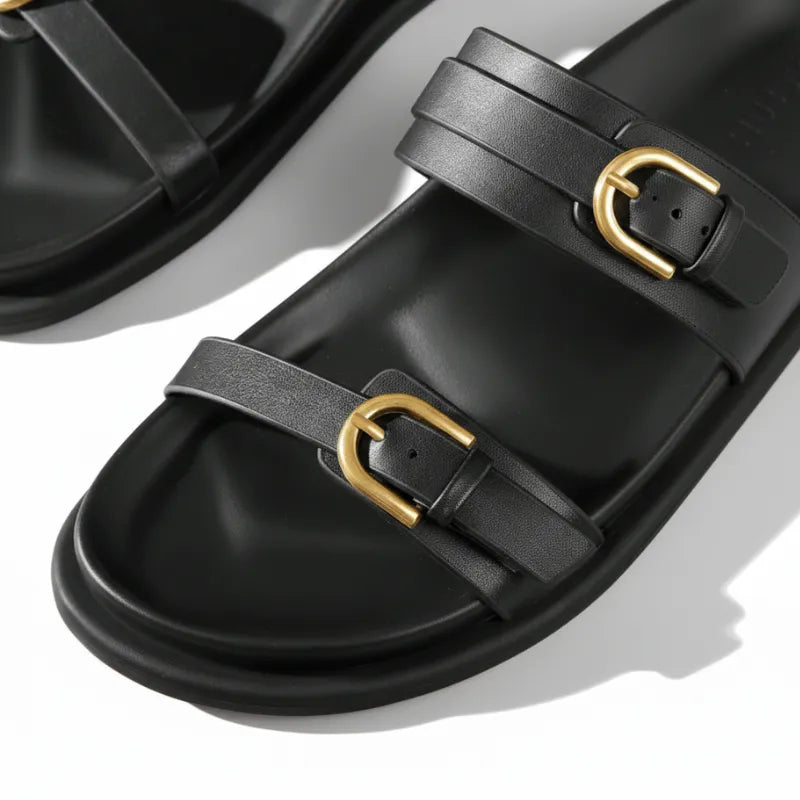 Papete preta com dupla fivela dourada em angulo lateral mostrando os dois pares.