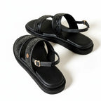 Papete preto flatform com fivela vista de cima, mostrando palmilha, tiras metálicas e formato completo do par